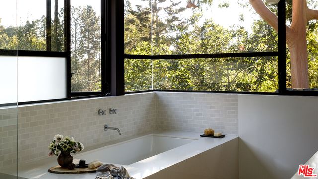 a bathroom with a bathtub and window
