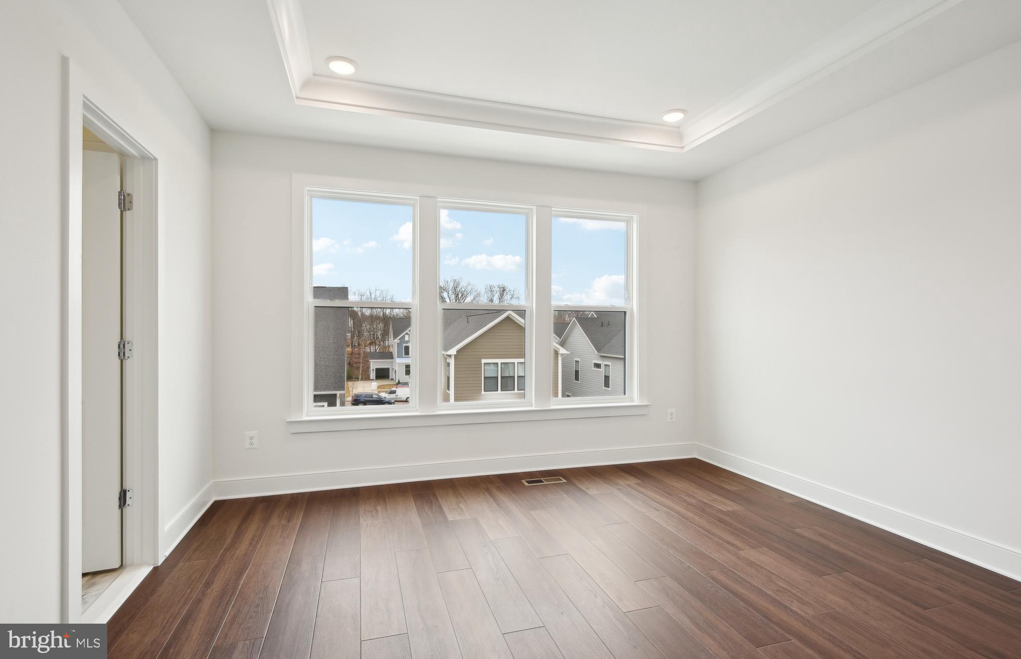 42601 Houdini Rst Terrace Leesburg, VA 20176 - Photo 16 of 52 an empty room with wooden floor and a window