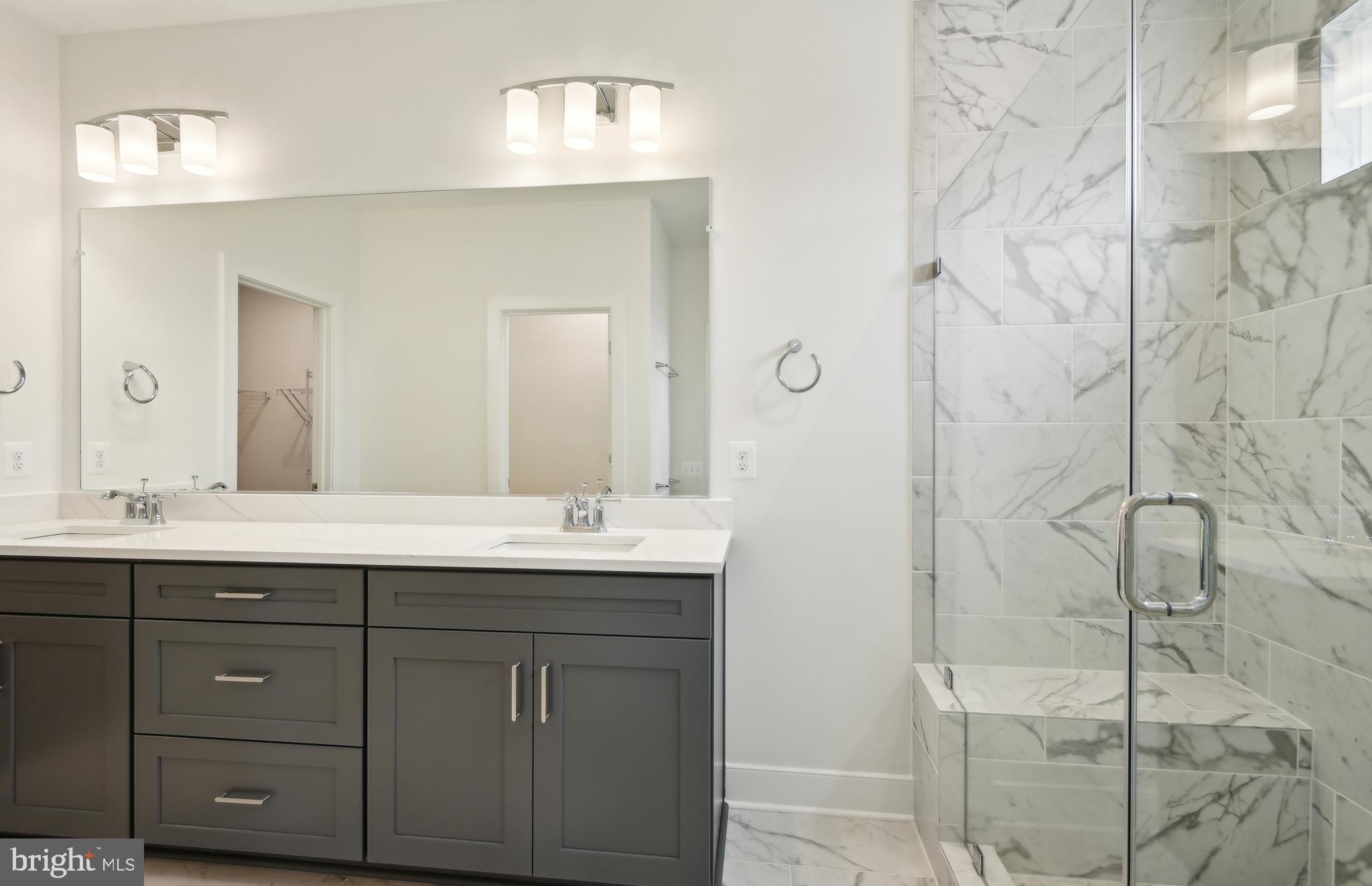 42601 Houdini Rst Terrace Leesburg, VA 20176 - Photo 20 of 52 a bathroom with a double vanity sink and mirror with shower