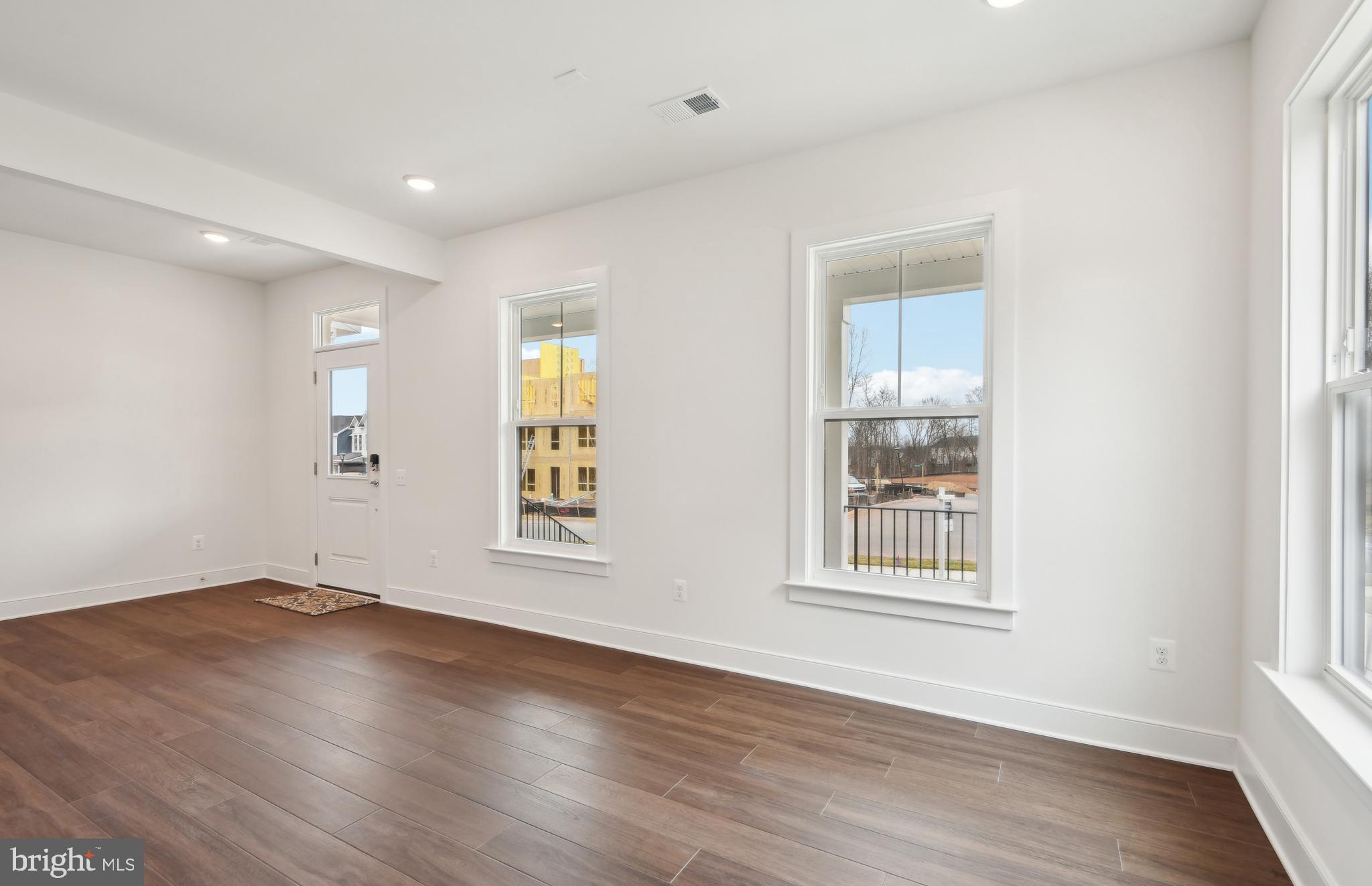 42601 Houdini Rst Terrace Leesburg, VA 20176 - Photo 2 of 52 a view of an empty room with wooden floor and a window