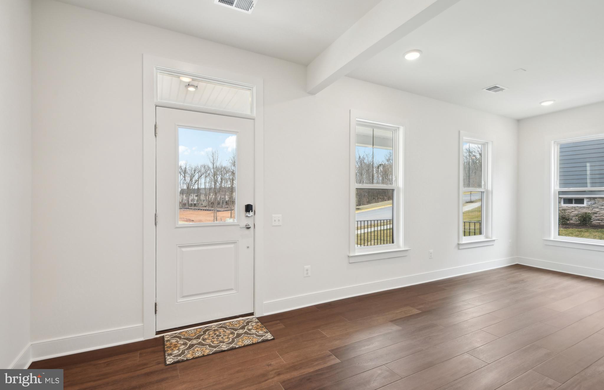 42601 Houdini Rst Terrace Leesburg, VA 20176 - Photo 3 of 52 an empty room with wooden floor and windows