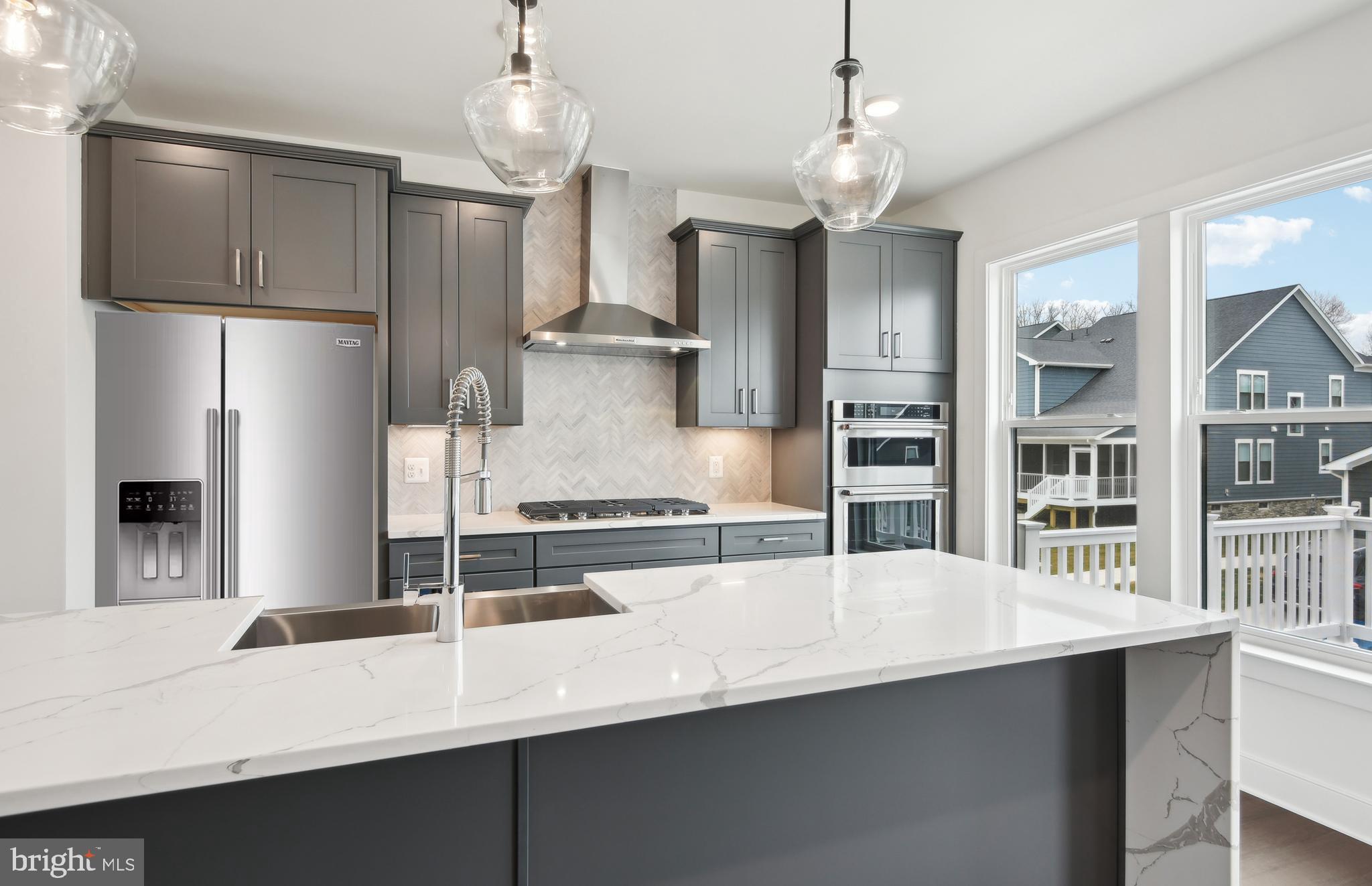 42601 Houdini Rst Terrace Leesburg, VA 20176 - Photo 7 of 52 a kitchen with stainless steel appliances a sink stove and refrigerator