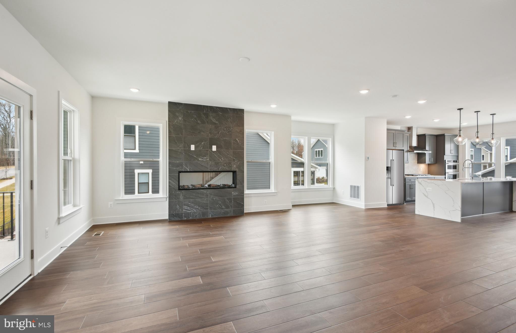 42601 Houdini Rst Terrace Leesburg, VA 20176 - Photo 10 of 52 a view of a big room with wooden floor and windows