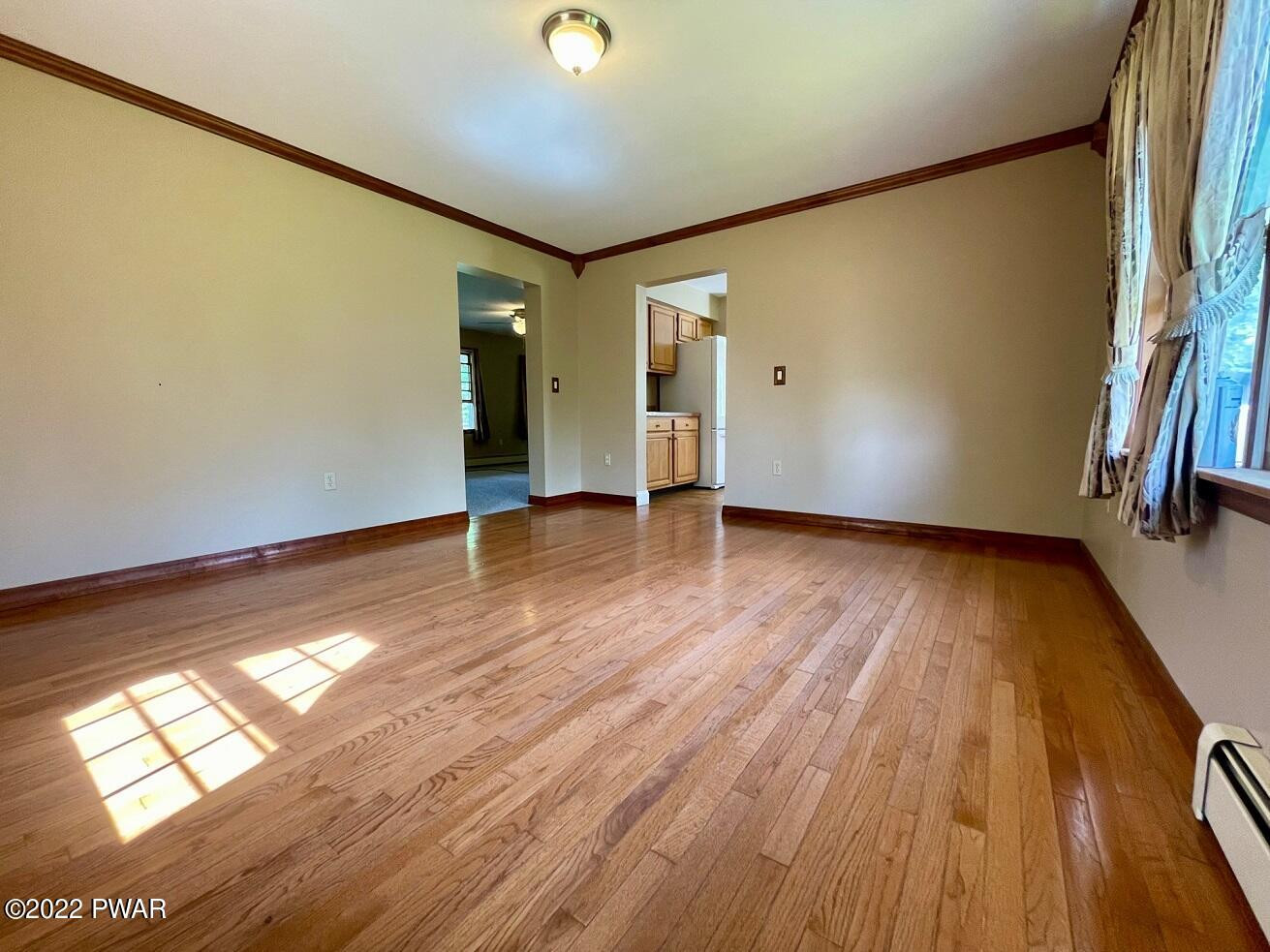 524 Creamton Drive Prompton, PA 18456 - Photo 17 of 57 an empty room with wooden floor and windows