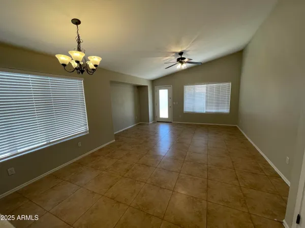 a view of a room with a chandelier furniture and windows