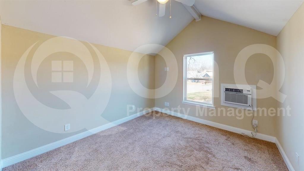 3005 Meandering Way Bedford, TX 76021 - Photo 14 of 24 Vaulted ceilings with a ceiling fan, carpeted flooring, a window providing natural light, and a wall-mounted air conditioning unit