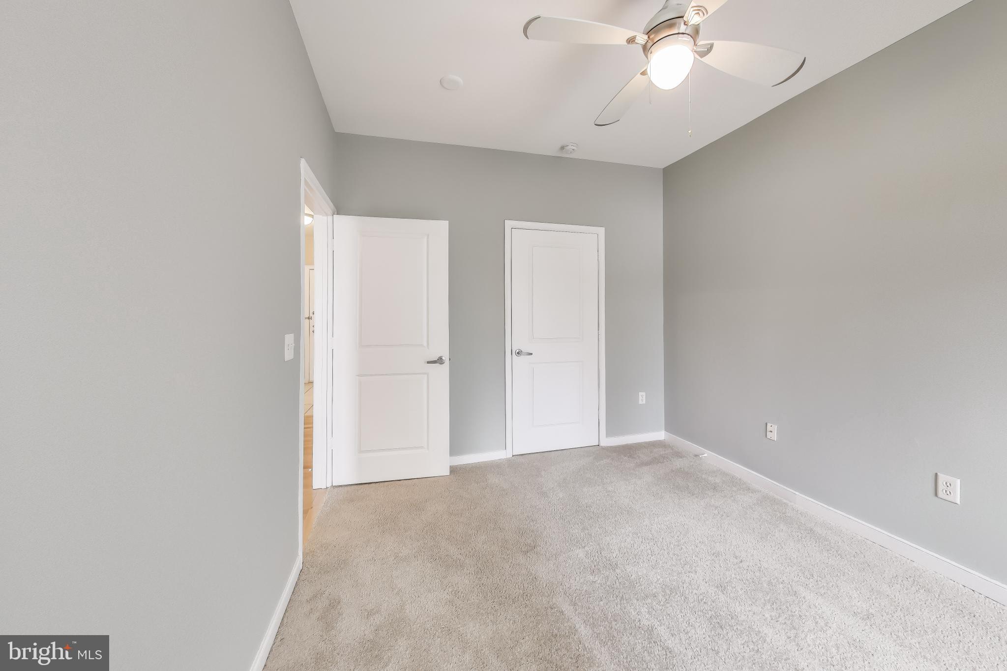 8045 Newell Street, Unit 108 Silver Spring, MD 20910 - Photo 14 of 33 a view of an empty room and chandelier fan