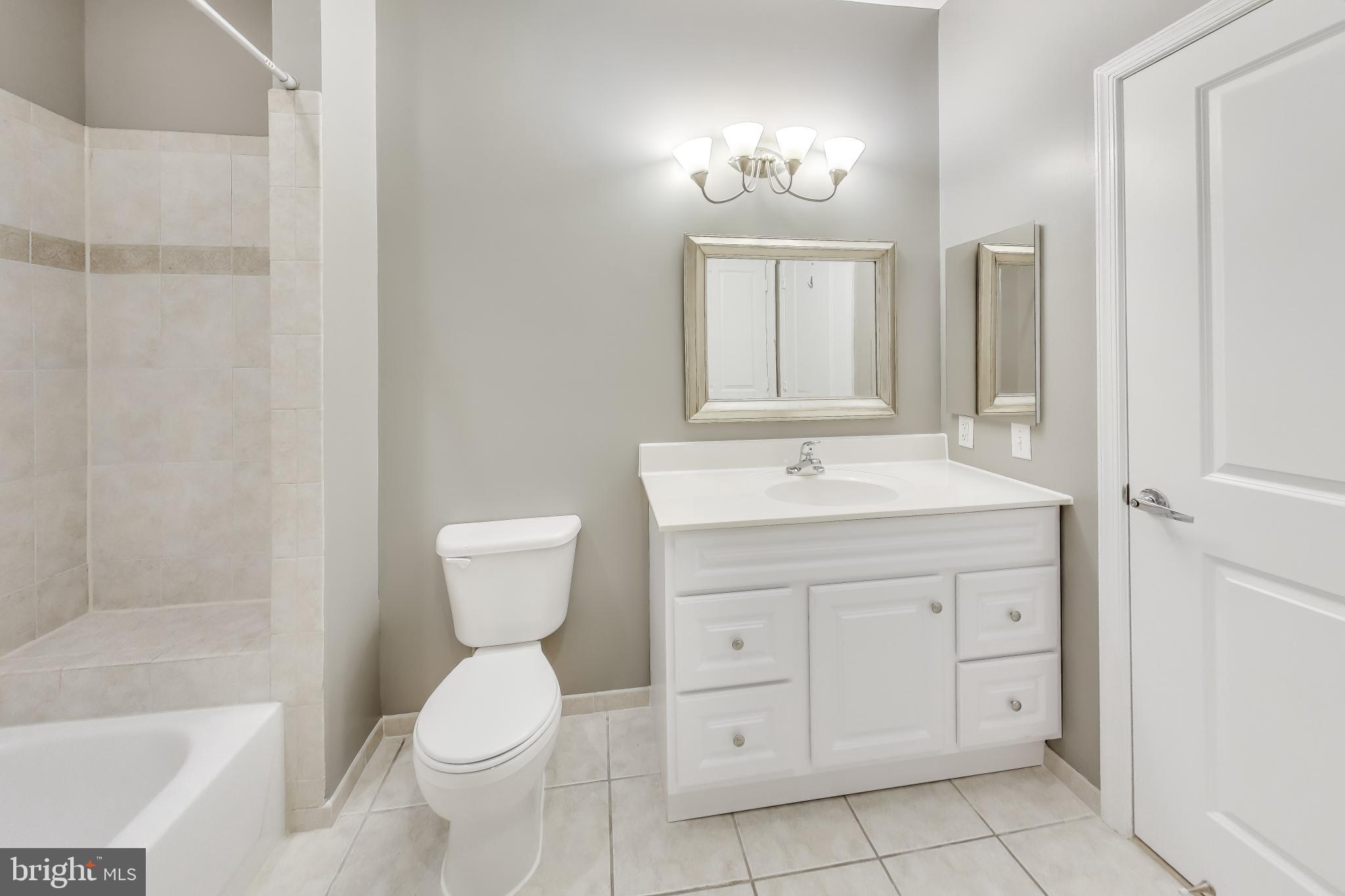 8045 Newell Street, Unit 108 Silver Spring, MD 20910 - Photo 15 of 33 a bathroom with a toilet sink and mirror