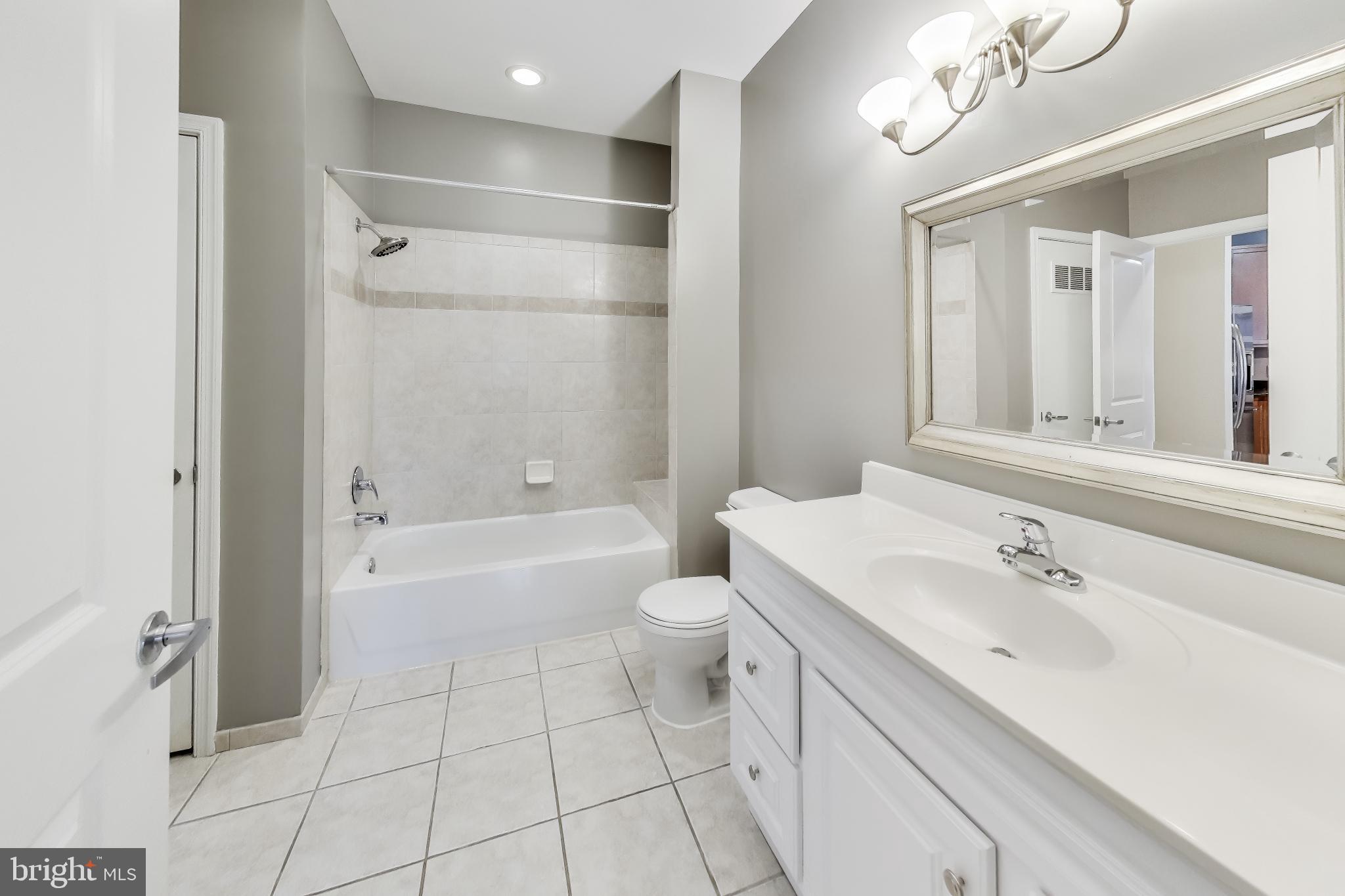 8045 Newell Street, Unit 108 Silver Spring, MD 20910 - Photo 16 of 33 a bathroom with a sink a toilet and shower
