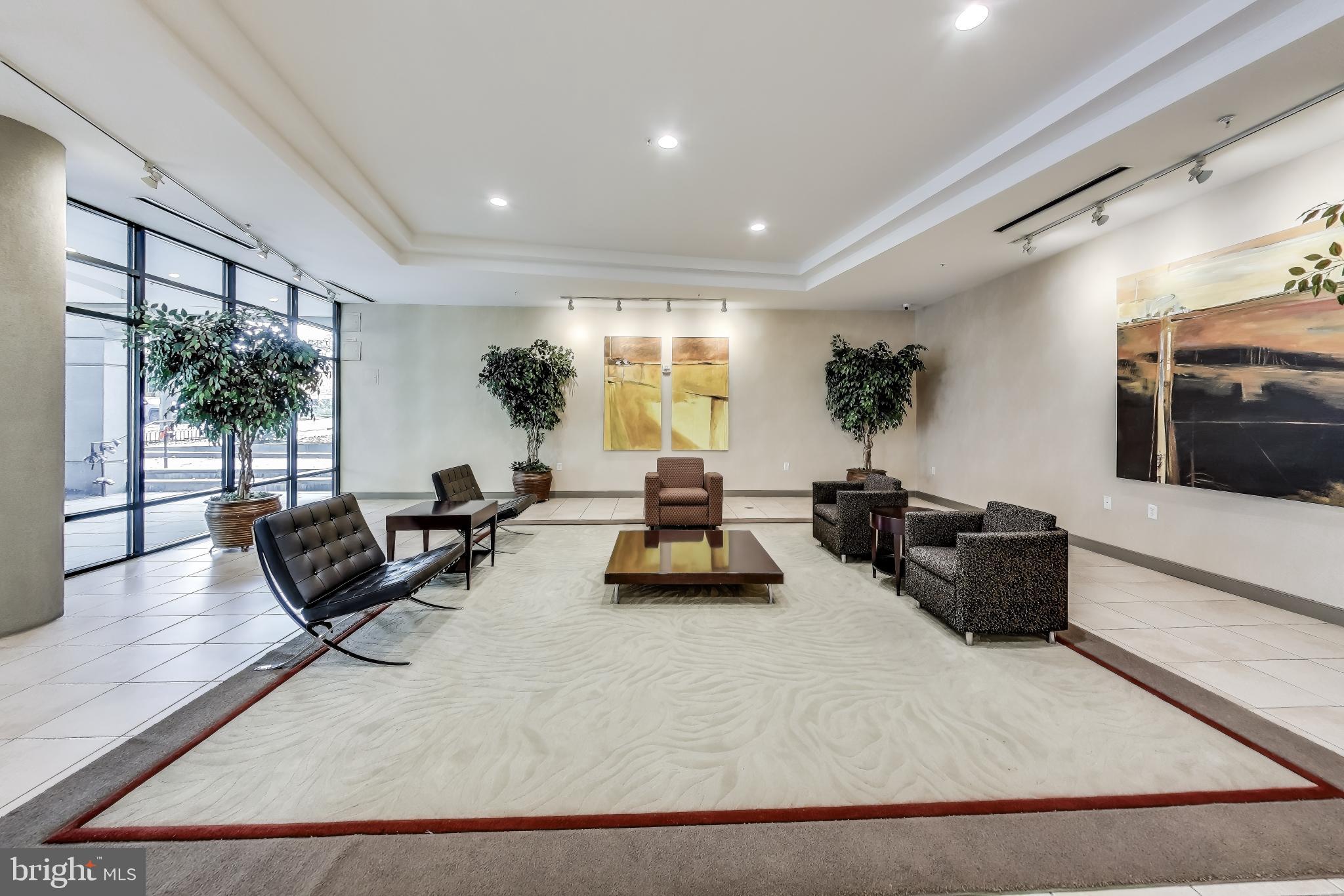 8045 Newell Street, Unit 108 Silver Spring, MD 20910 - Photo 23 of 33 a living room with furniture and a large window