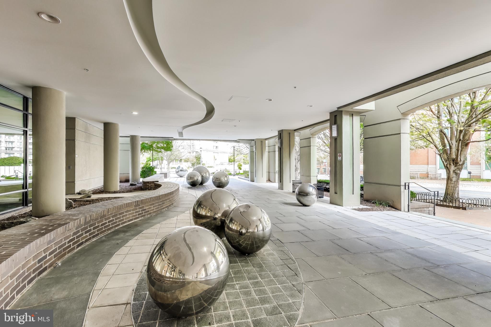 8045 Newell Street, Unit 108 Silver Spring, MD 20910 - Photo 24 of 33 a very nice looking bedroom with a large window and a chandelier