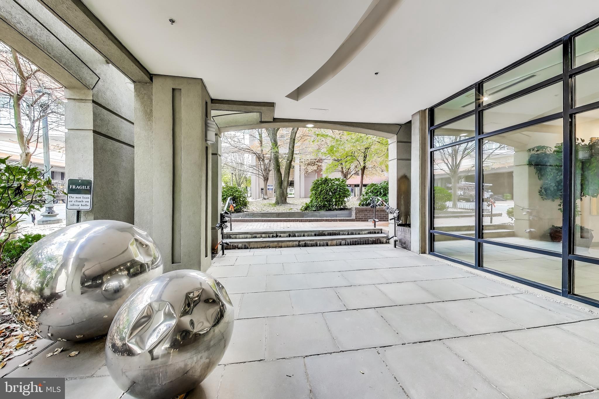8045 Newell Street, Unit 108 Silver Spring, MD 20910 - Photo 25 of 33 a spacious bedroom with a bed and glass windows