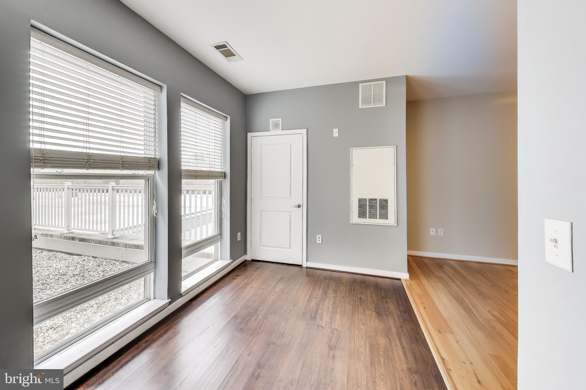 8045 Newell Street, Unit 108 Silver Spring, MD 20910 - Photo 6 of 33 a view of hallway with a large window and wooden floor