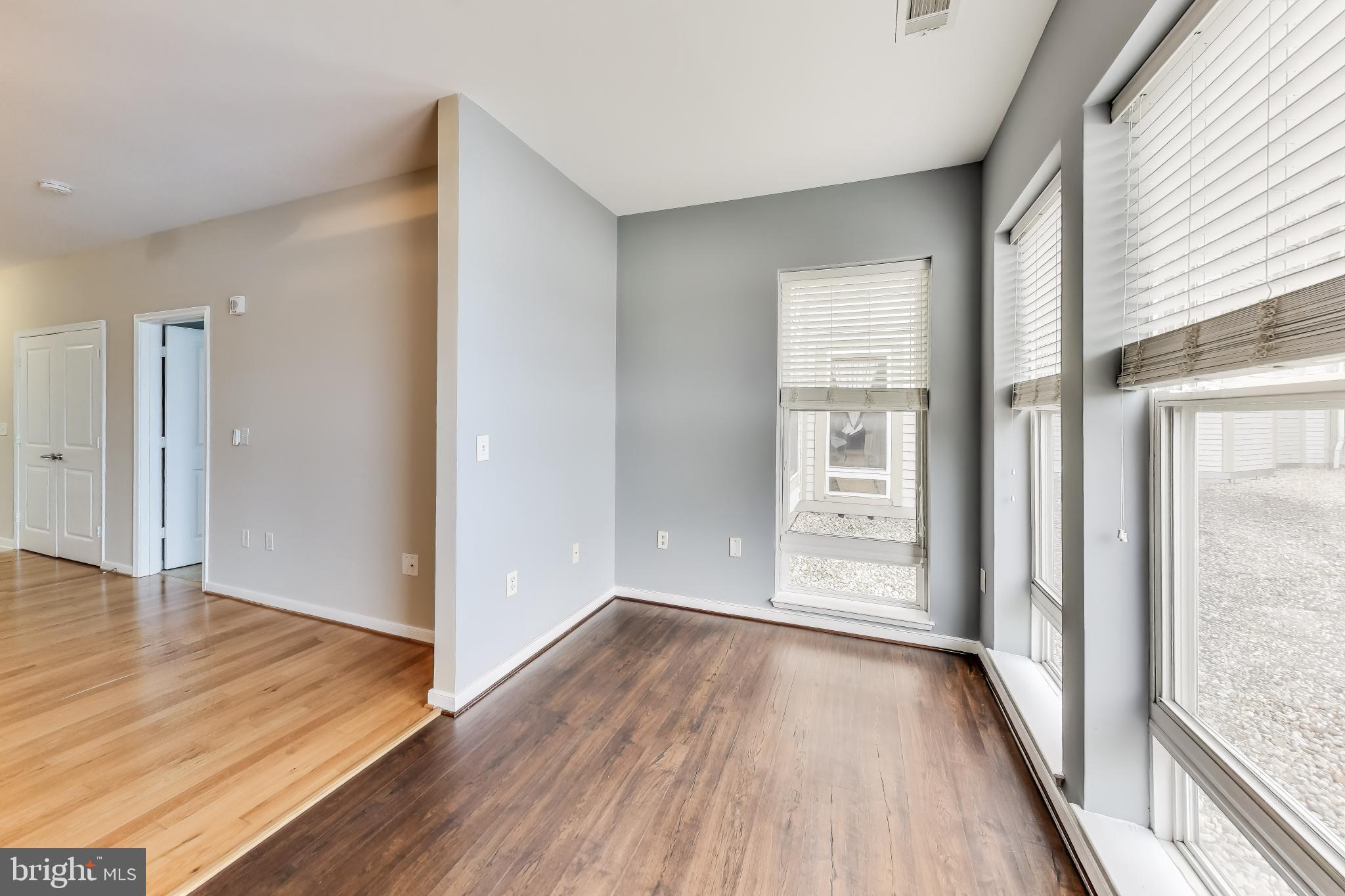 8045 Newell Street, Unit 108 Silver Spring, MD 20910 - Photo 7 of 33 wooden floor in an empty room with a window