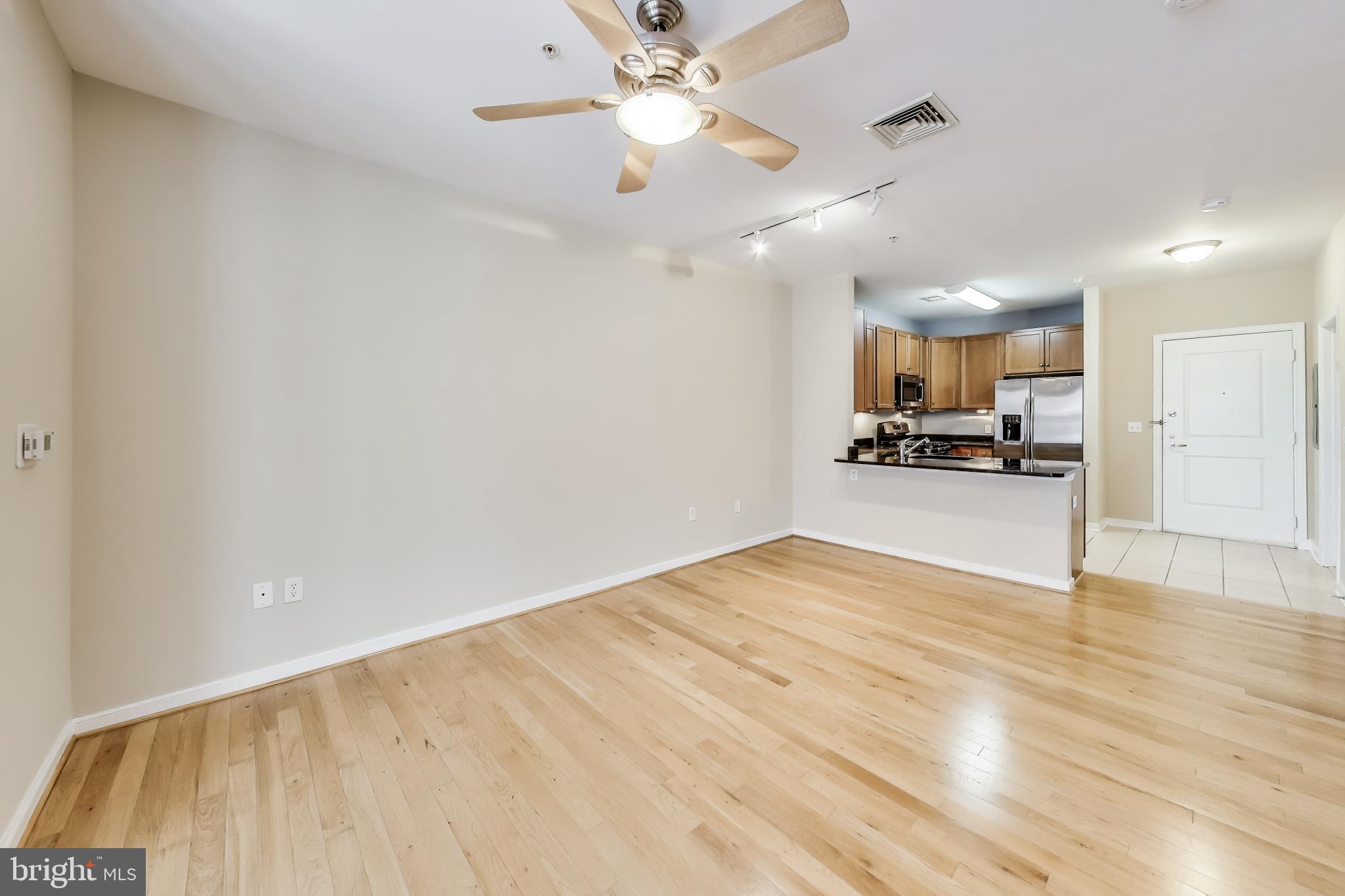 8045 Newell Street, Unit 108 Silver Spring, MD 20910 - Photo 8 of 33 a view of kitchen with granite countertop cabinets and refrigerator