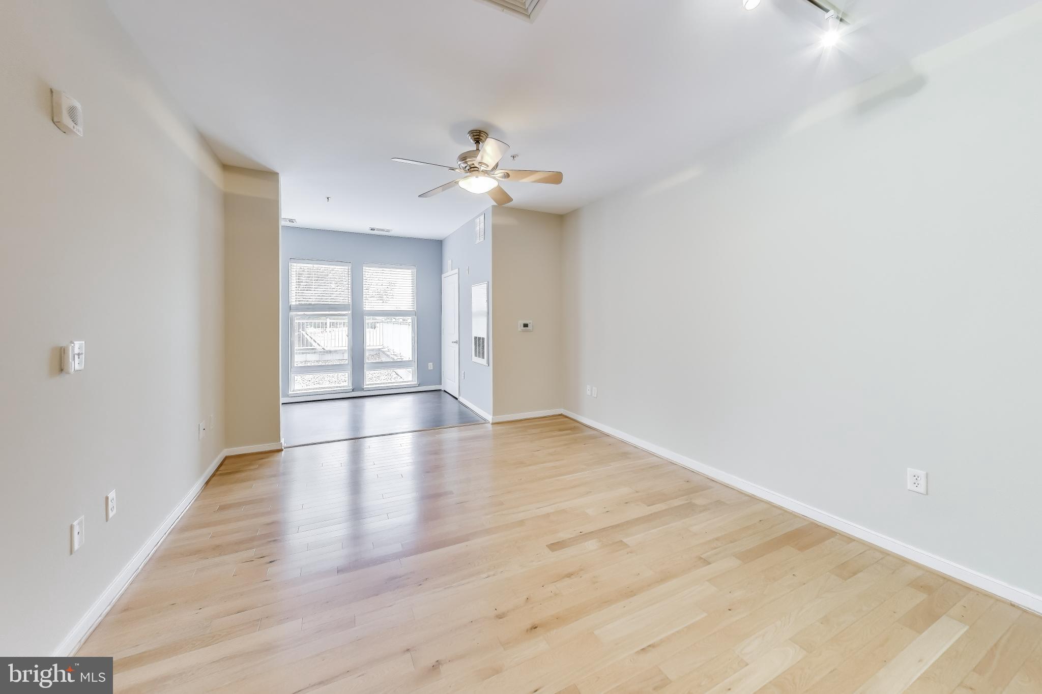 8045 Newell Street, Unit 108 Silver Spring, MD 20910 - Photo 9 of 33 wooden floor in an empty room with a window