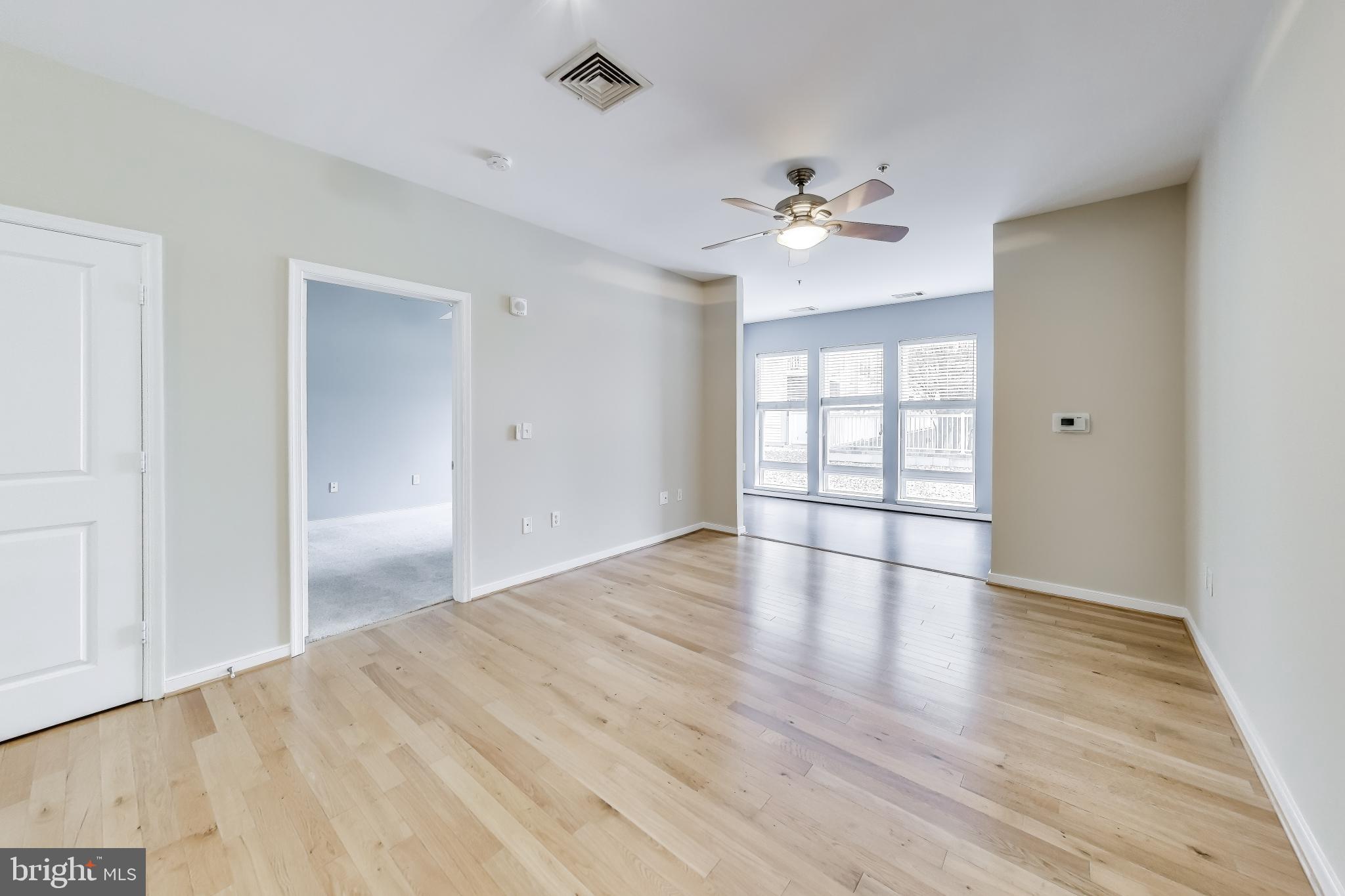 8045 Newell Street, Unit 108 Silver Spring, MD 20910 - Photo 10 of 33 wooden floor in an empty room with a window