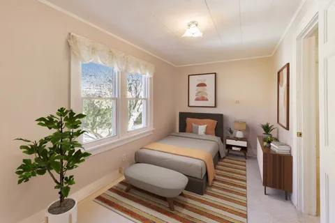 a bedroom with furniture and a window