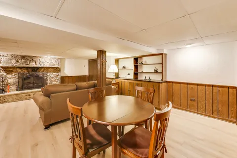 a dining room with furniture and wooden floor