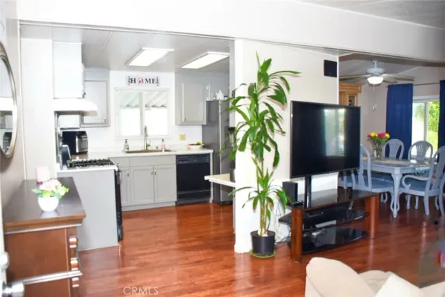 a kitchen with stainless steel appliances a stove a sink a refrigerator and cabinets