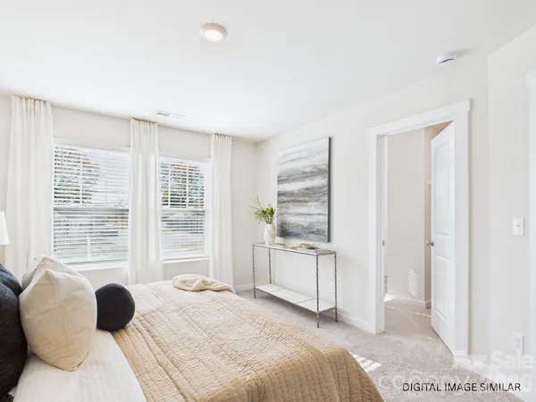 a bedroom with bed and a large window