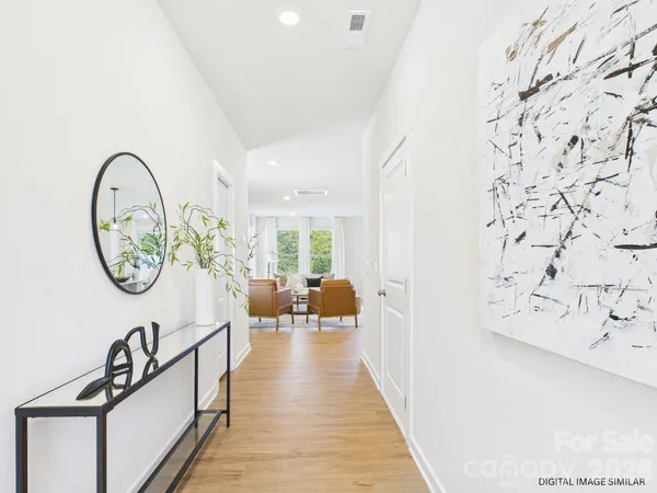 a view of a hallway with paintings on the wall