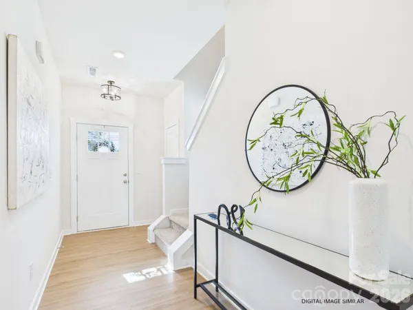 a view of a kitchen with kitchen island a sink wooden floor and a large window