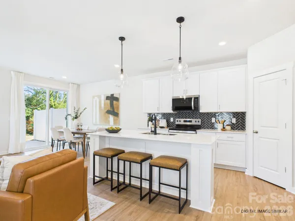 a kitchen with microwave a stove and furniture