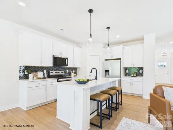 a kitchen with a sink and chandelier