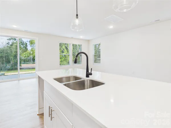 a living room with furniture potted plant and a window