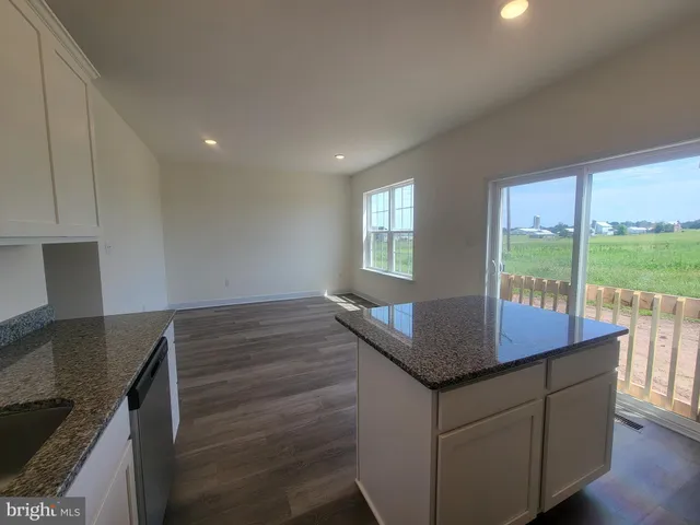 a kitchen with kitchen island a sink table and chairs