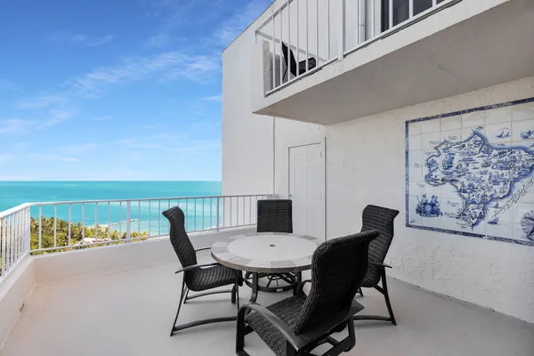 a view of a chairs and table in the balcony