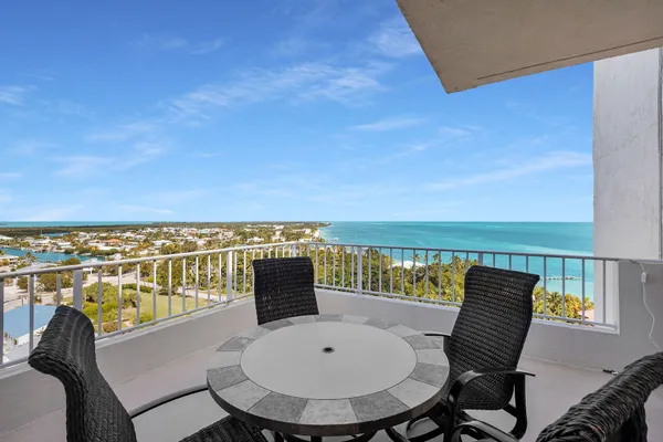 a balcony with table and chairs