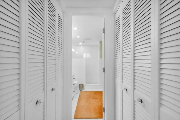 an aerial view of a city with lots of residential buildings ocean and mountain view in back