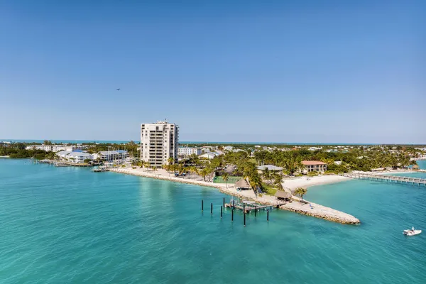 a kitchen with a dining table chairs and refrigerator