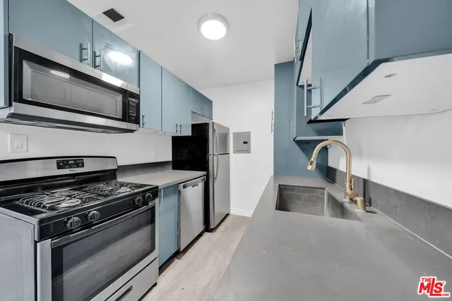 a kitchen with stainless steel appliances granite countertop a stove and a microwave