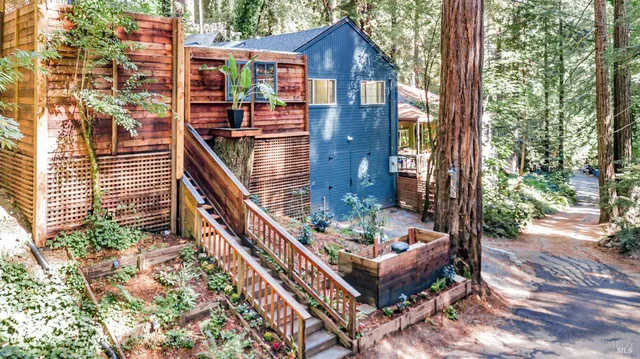 a view of a house with backyard and sitting area