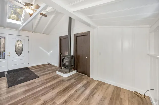 a view of a room with wooden floor and windows