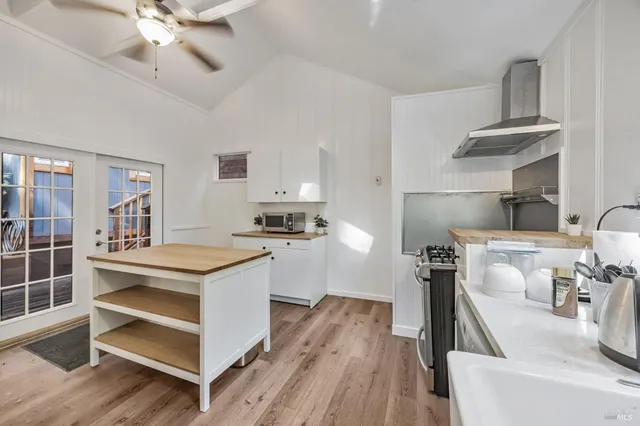 a kitchen with a stove a sink and a refrigerator