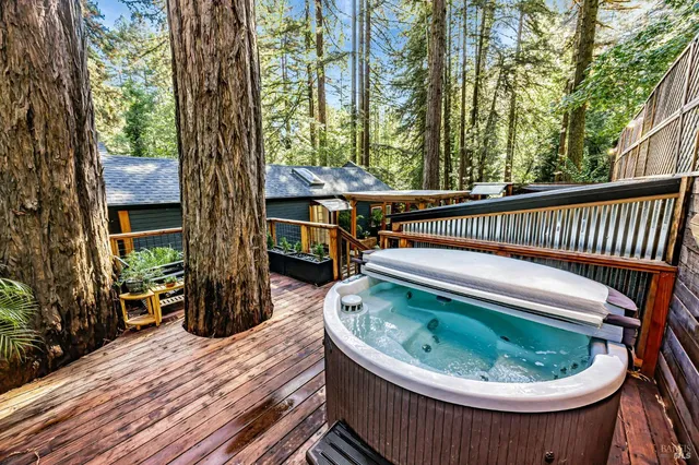 a roof deck with a table and chairs and wooden floor