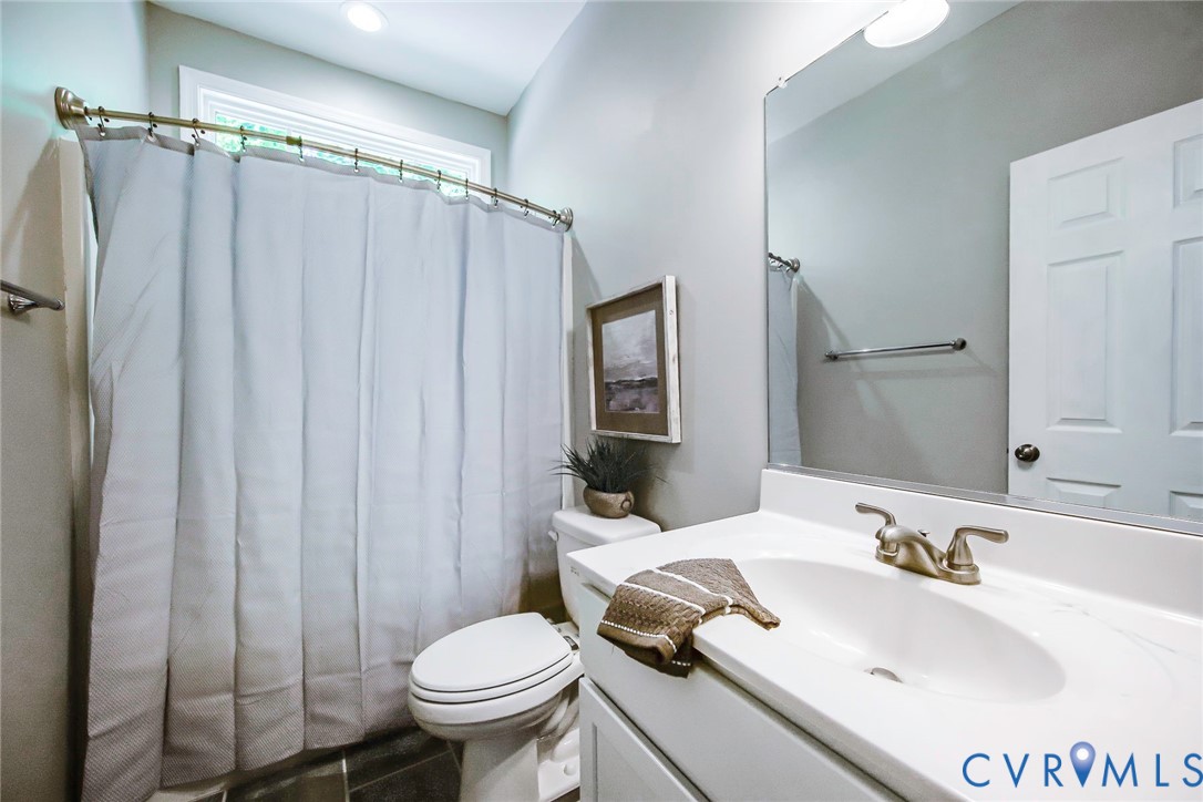 1297 Manfield Road Aylett, VA 23009 - Photo 16 of 41 a bathroom with a sink toilet and shower