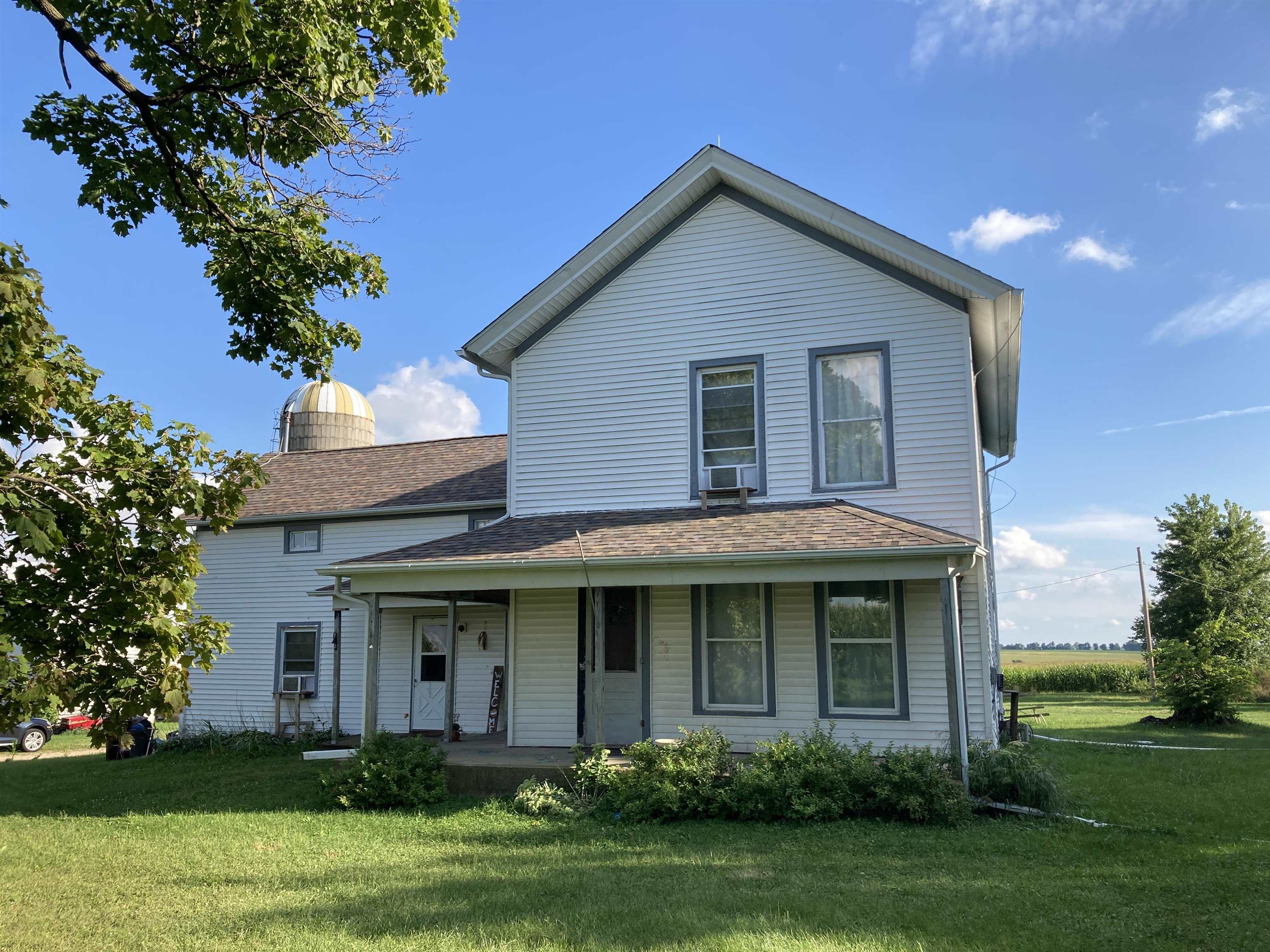 15702 Farm School Road Durand, IL 61024 - Photo 1 of 38 a front view of a house with a yard and trees