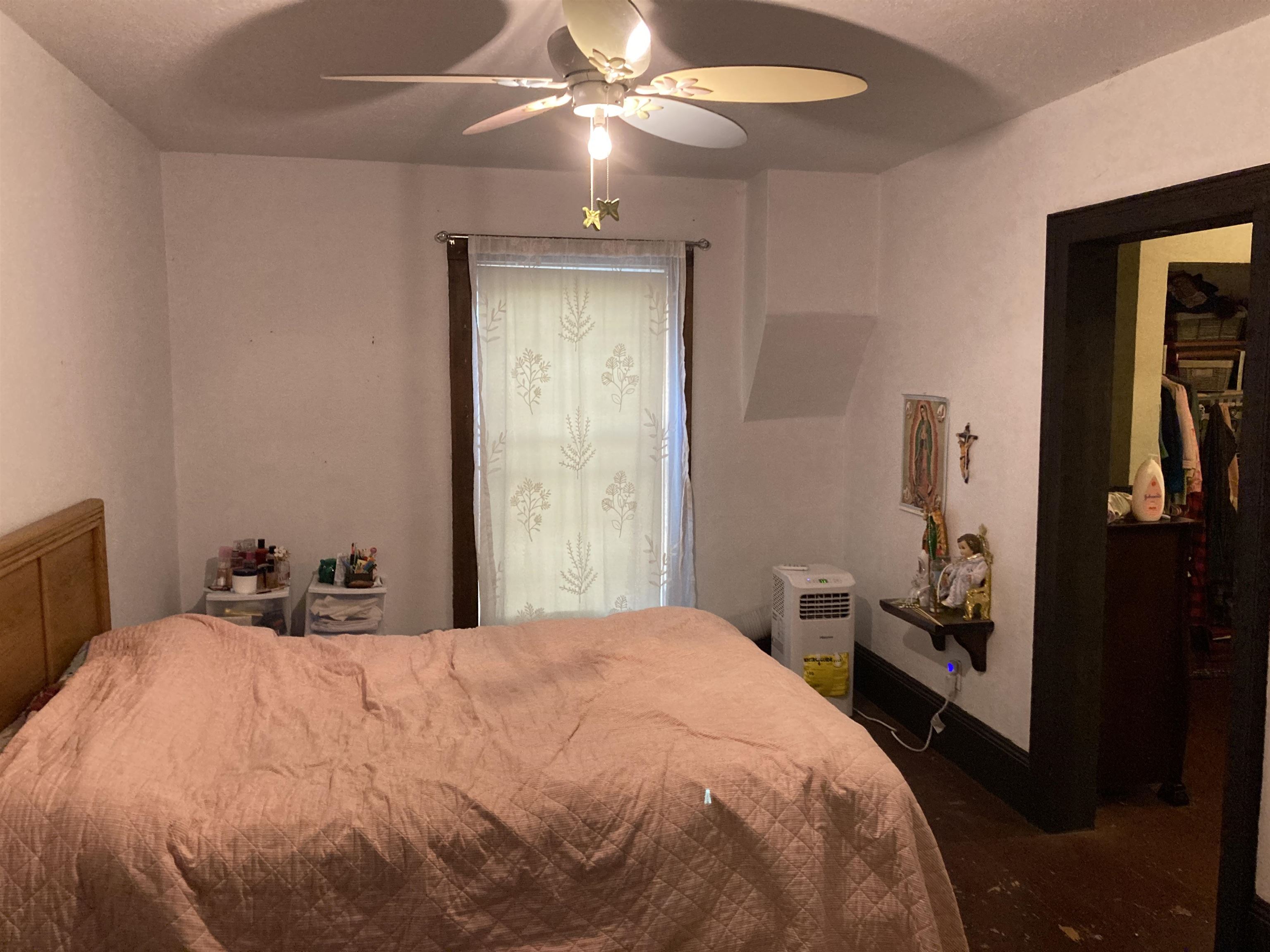 15702 Farm School Road Durand, IL 61024 - Photo 33 of 38 a bedroom with a bed and a chandelier