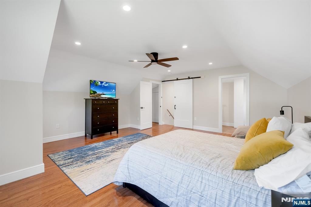 433 Piermont Road Cresskill, NJ 07626 - Photo 30 of 49 a bedroom with a bed and a chandelier