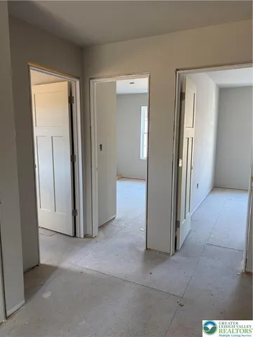 an empty room with windows and bathroom view