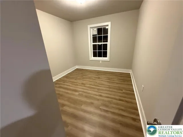 a view of an empty room with windows