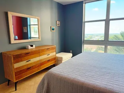 a bedroom with two beds and a window
