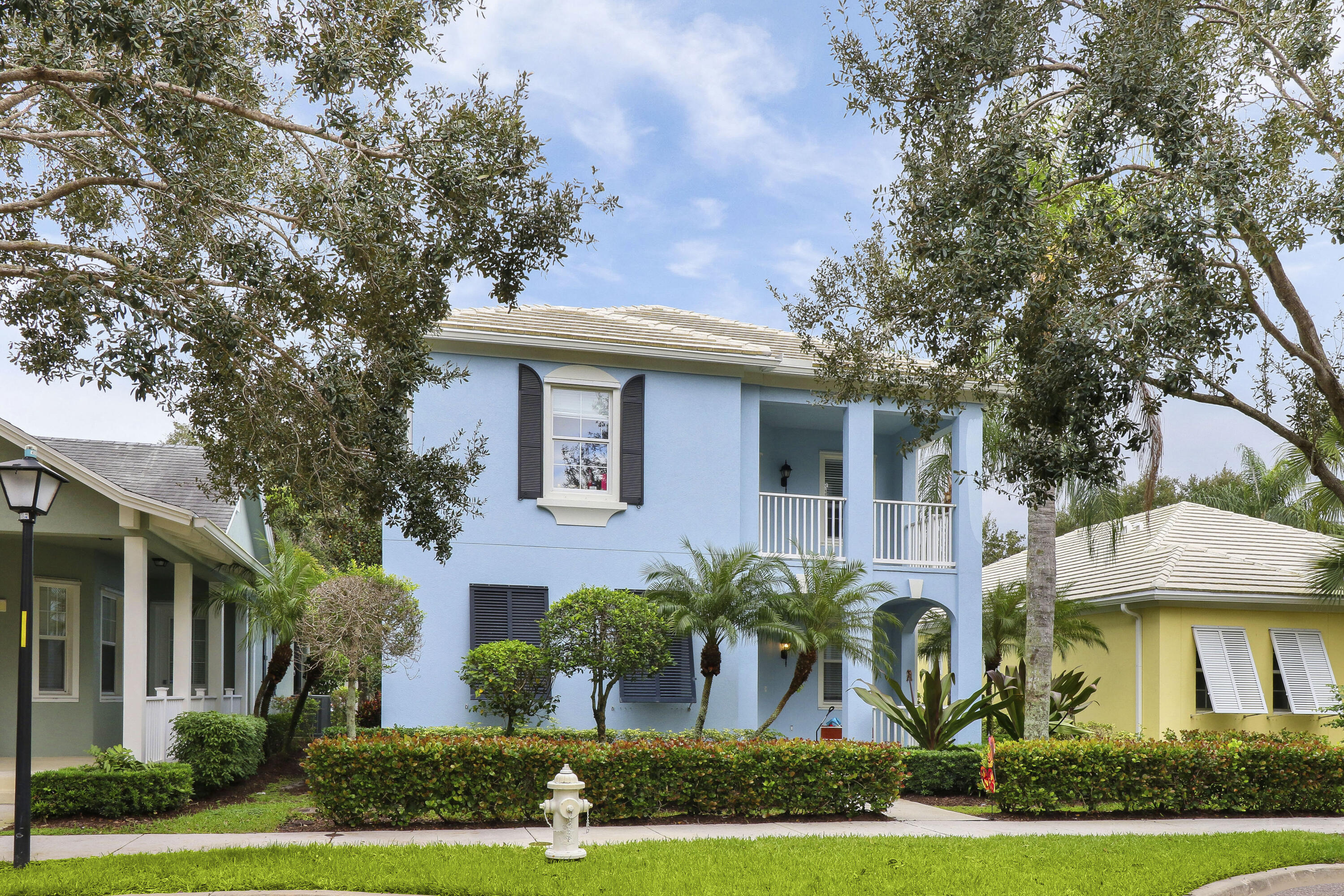 263 Caravelle Drive Jupiter, FL 33458 - Photo 2 of 14 front view of a house with a yard