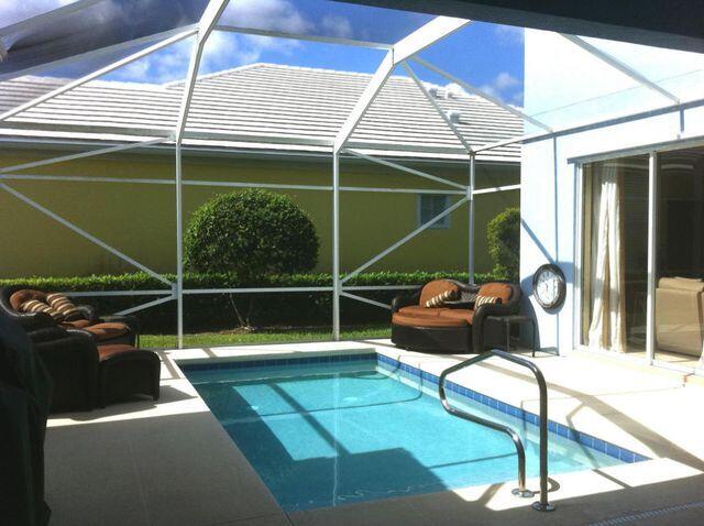 263 Caravelle Drive Jupiter, FL 33458 - Photo 3 of 14 a backyard of a house with table and chairs