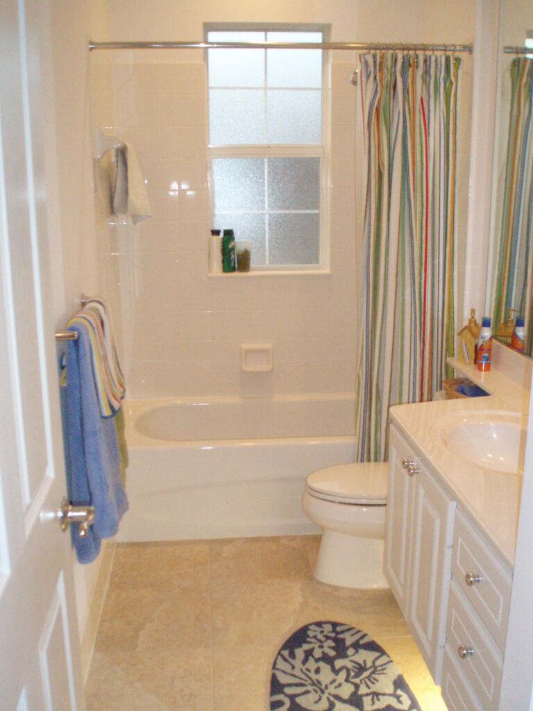 263 Caravelle Drive Jupiter, FL 33458 - Photo 7 of 14 a bathroom with a sink a toilet and shower
